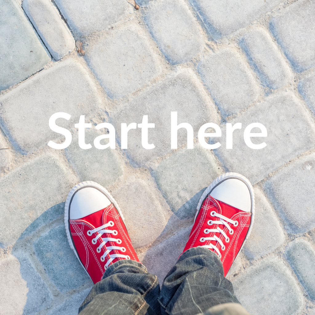 A pair of red shoes on a cobblestone pavement